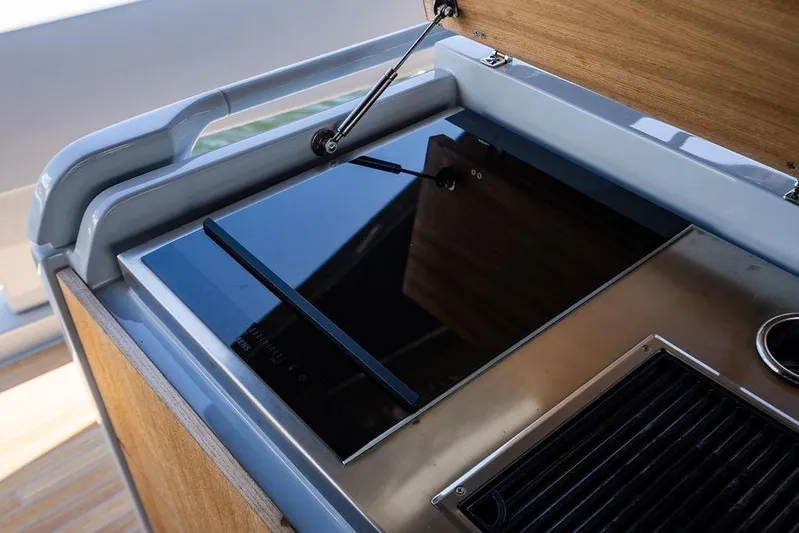 Snack Money Yacht Photos Pics 2023 Bluegame BG 72 yacht kitchen with sleek modern stovetop design.