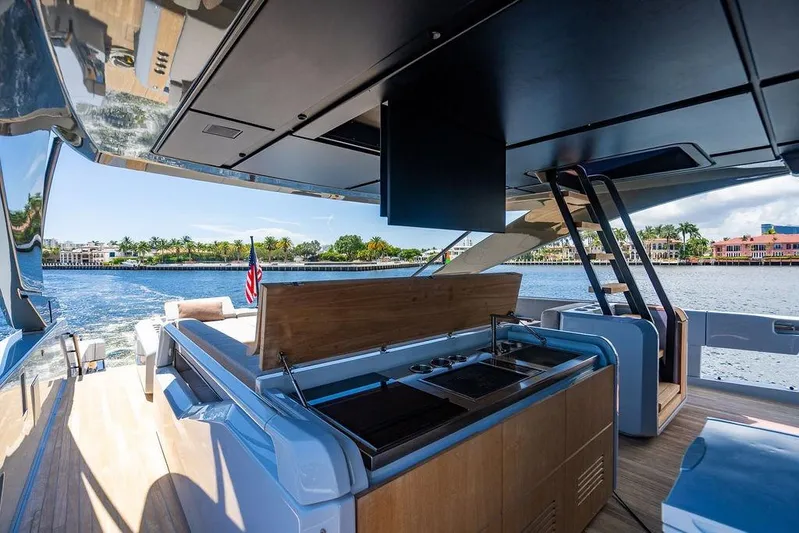 Snack Money Yacht Photos Pics Luxurious 2023 Bluegame BG 72 yacht with outdoor kitchen, cruising on scenic waterfront.