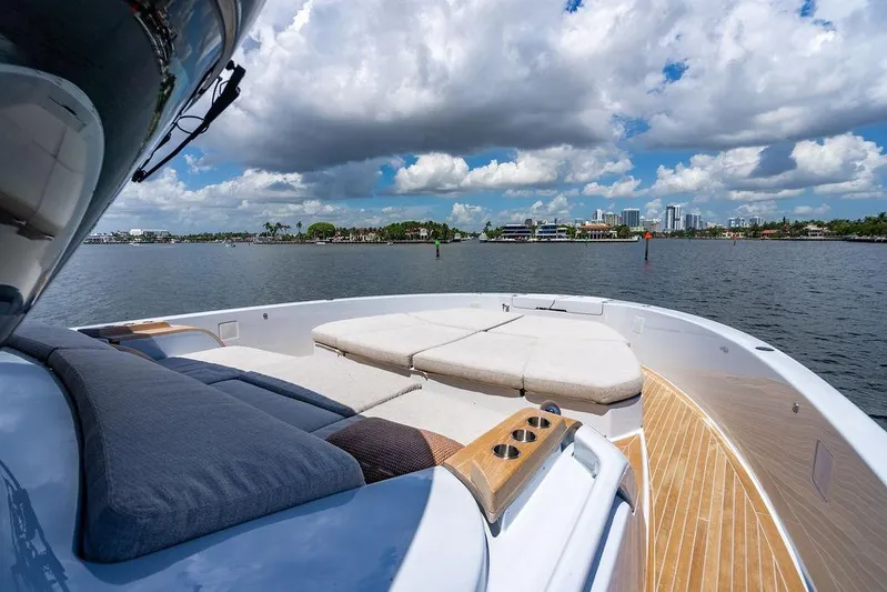 Snack Money Yacht Photos Pics Luxurious 2023 Bluegame BG 72 yacht with spacious deck and scenic waterfront view.