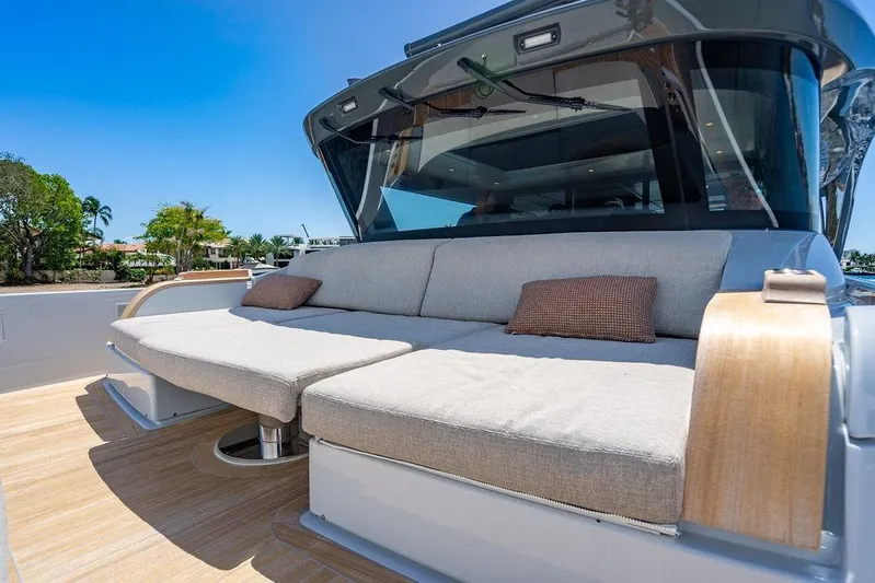 Snack Money Yacht Photos Pics Luxurious 2023 Bluegame BG 72 yacht with spacious outdoor seating area.