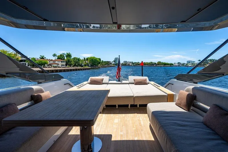 Snack Money Yacht Photos Pics Luxurious 2023 Bluegame BG 72 yacht interior with elegant seating and scenic water view.