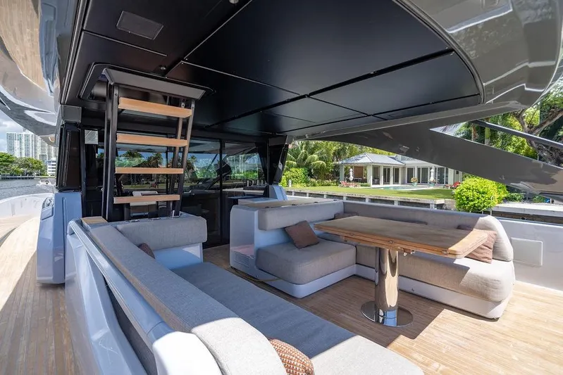 Snack Money Yacht Photos Pics Luxurious 2023 Bluegame BG 72 yacht interior with modern seating and wooden table.