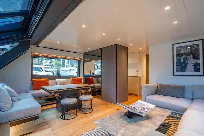 Snack Money Yacht Photos Pics Luxurious interior of 2023 Bluegame BG 72 yacht with modern seating and decor.