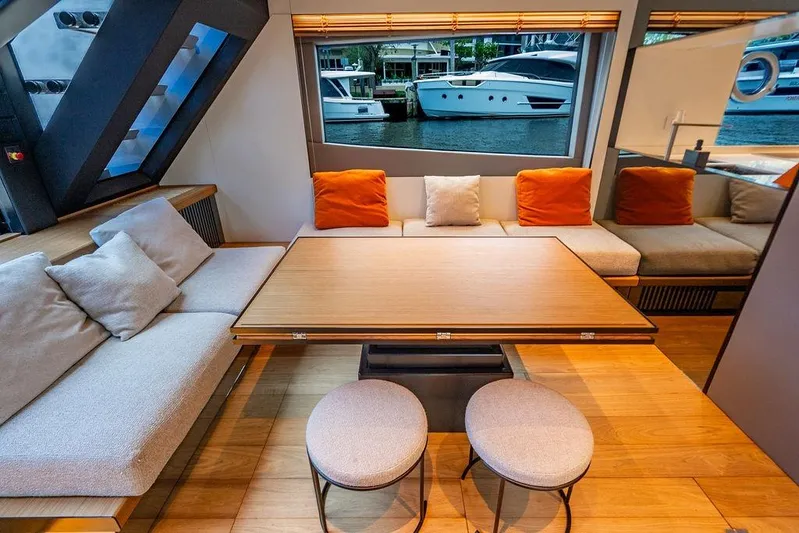Snack Money Yacht Photos Pics Luxurious interior of 2023 Bluegame BG 72 yacht with modern seating and waterfront view.