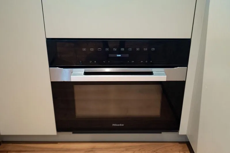 Snack Money Yacht Photos Pics Modern built-in Miele oven with digital controls, sleek design, and stainless steel handle.