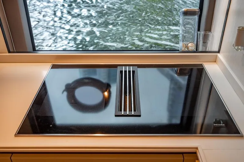 Snack Money Yacht Photos Pics Modern kitchen cooktop on Bluegame BG 72 yacht, 2023 model, with water view.