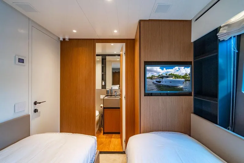 Snack Money Yacht Photos Pics Interior of 2023 Bluegame BG 72 yacht cabin with twin beds and TV.