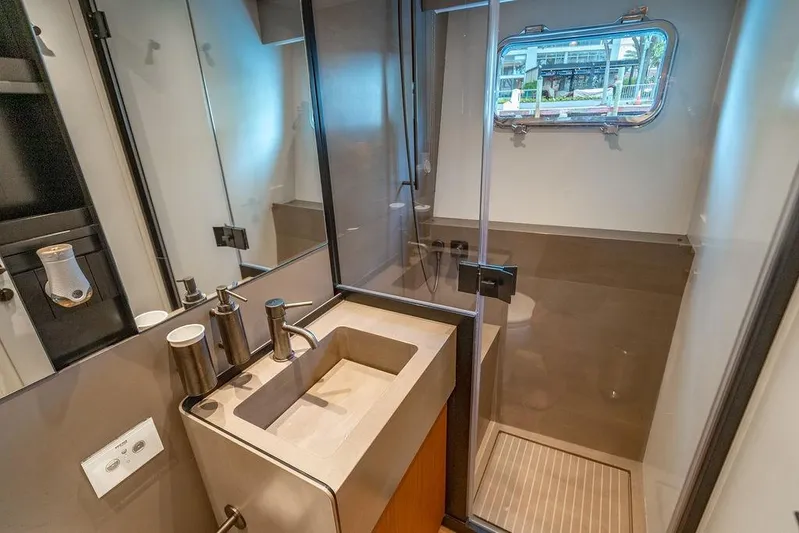 Snack Money Yacht Photos Pics Modern bathroom interior on 2023 Bluegame BG 72 yacht, featuring sleek sink and shower.