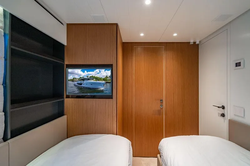 Snack Money Yacht Photos Pics Interior of 2023 Bluegame BG 72 yacht cabin with twin beds and wall-mounted TV.