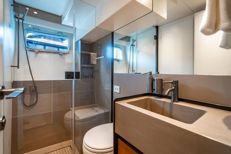 Snack Money Yacht Photos Pics Luxurious bathroom in 2023 Bluegame BG 72 yacht with modern fixtures and shower.