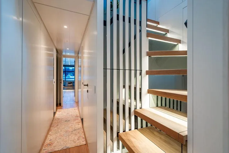 Snack Money Yacht Photos Pics Modern interior of 2023 Bluegame BG 72 yacht with sleek staircase and hallway.