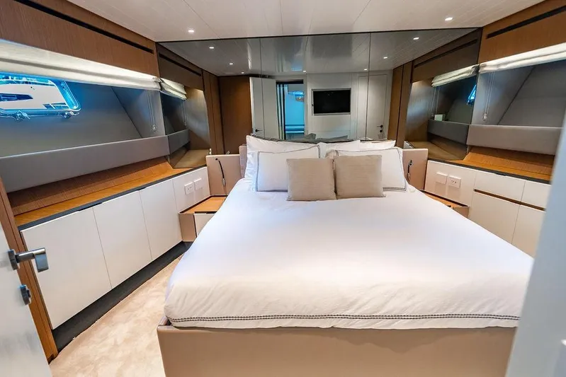 Snack Money Yacht Photos Pics Luxurious bedroom interior of 2023 Bluegame BG 72 yacht, featuring modern design and elegant furnishings.