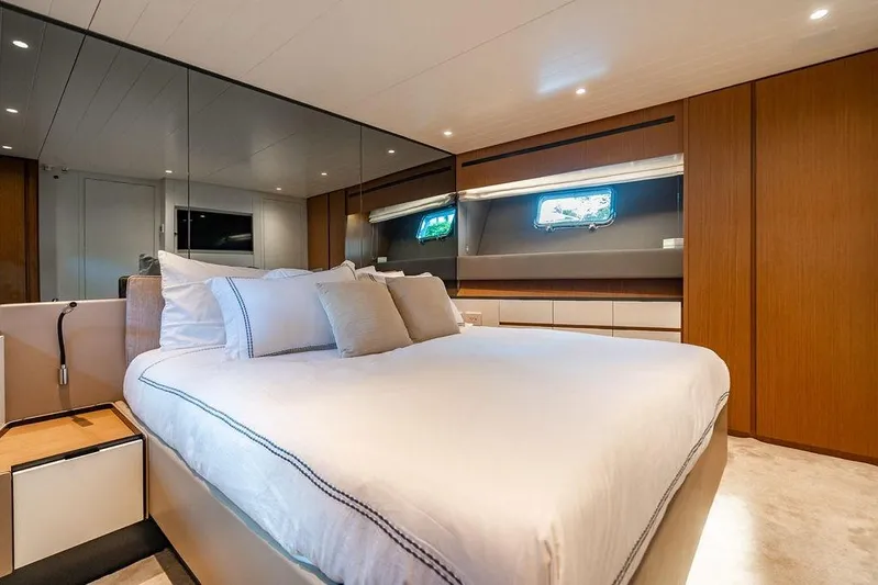 Snack Money Yacht Photos Pics Luxurious bedroom interior of 2023 Bluegame BG 72 yacht with modern design and elegant furnishings.