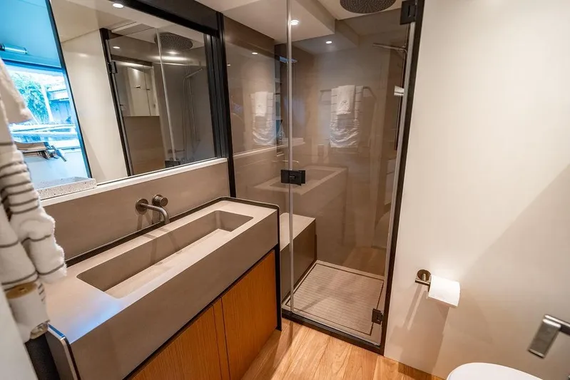 Snack Money Yacht Photos Pics Modern bathroom interior on 2023 Bluegame BG 72 yacht, featuring sleek design and glass shower.
