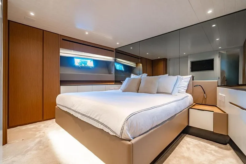 Snack Money Yacht Photos Pics Luxurious bedroom interior of 2023 Bluegame BG 72 yacht with modern design and cozy ambiance.