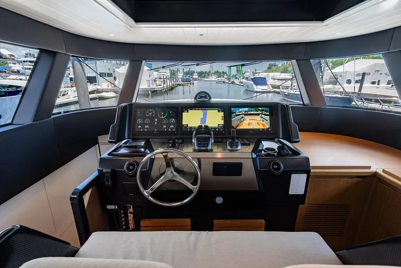 Snack Money Yacht Photos Pics 2023 Bluegame BG 72 yacht helm with advanced navigation displays and steering wheel.