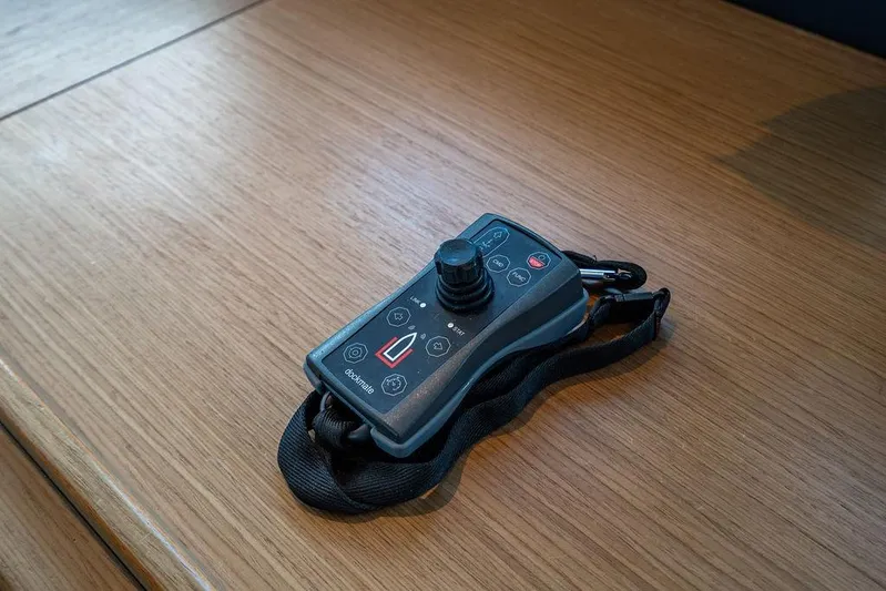 Snack Money Yacht Photos Pics Remote control device on wooden surface, associated with 2023 Bluegame BG 72 yacht.