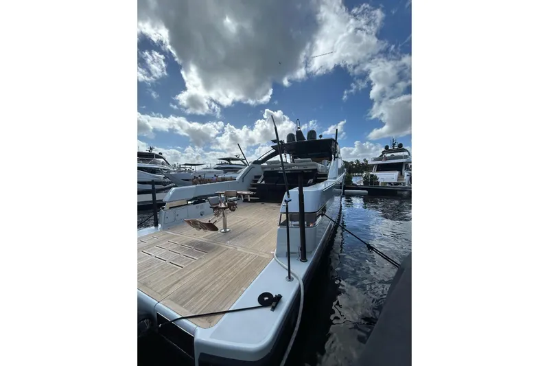 Snack Money Yacht Photos Pics 2023 Bluegame BG 72 yacht docked under a partly cloudy sky.