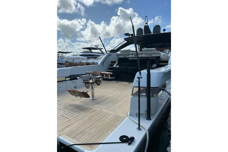 Snack Money Yacht Photos Pics 2023 Bluegame BG 72 yacht deck with seating, under a partly cloudy sky.