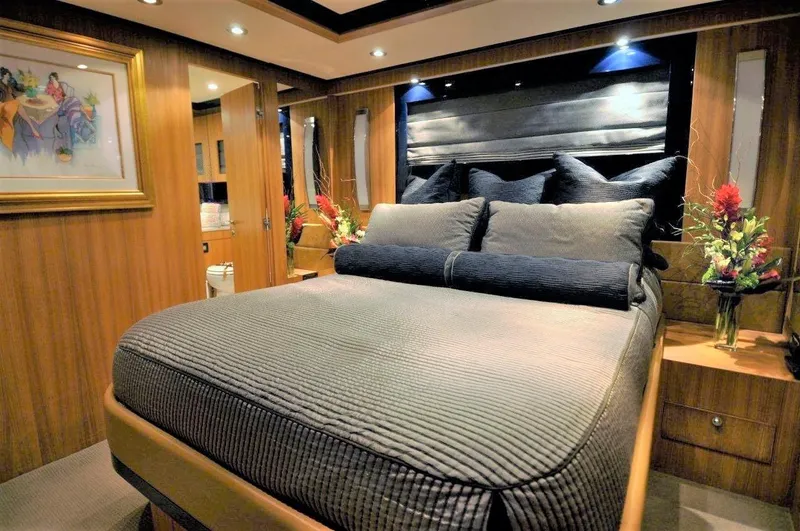 Bon Vivant Yacht Photos Pics Luxurious bedroom interior of 2004 Riva Splendida yacht with elegant decor and ambient lighting.