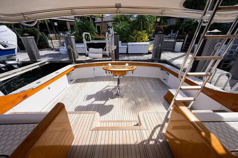 Ship's Cafe Yacht Photos Pics 1987 Merritt Boat Works Sport Fisherman with teak deck and fishing chair at dock.