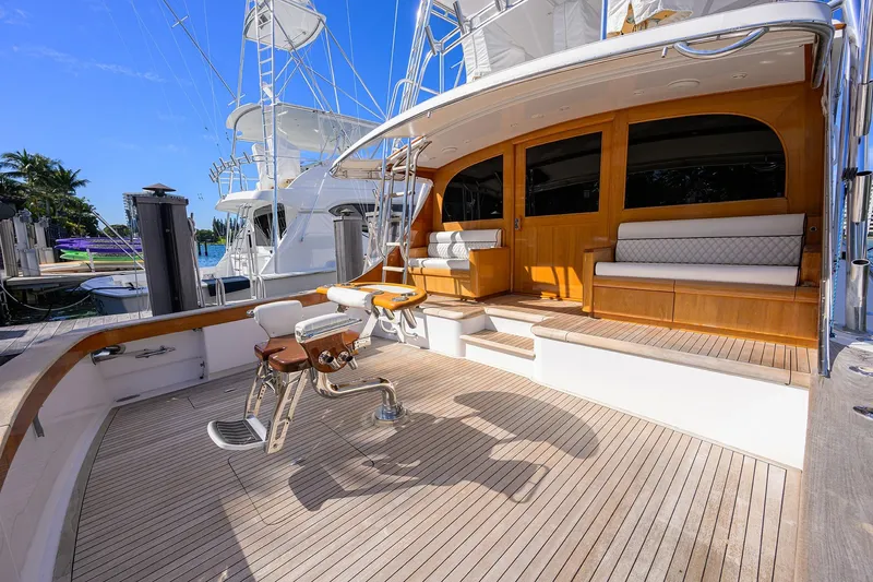Ship's Cafe Yacht Photos Pics 1987 Merritt Boat Works Sport Fisherman with teak deck and seating, docked under clear blue sky.