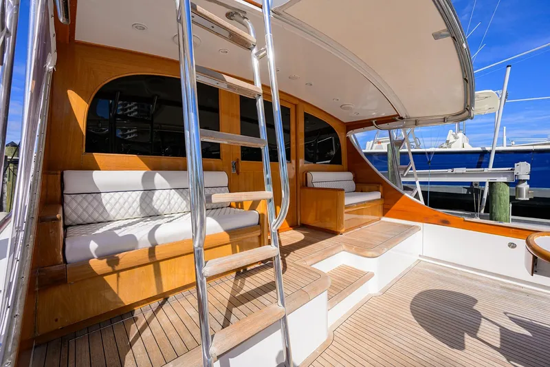 Ship's Cafe Yacht Photos Pics 1987 Merritt Boat Works Sport Fisherman with teak deck and cushioned seating.