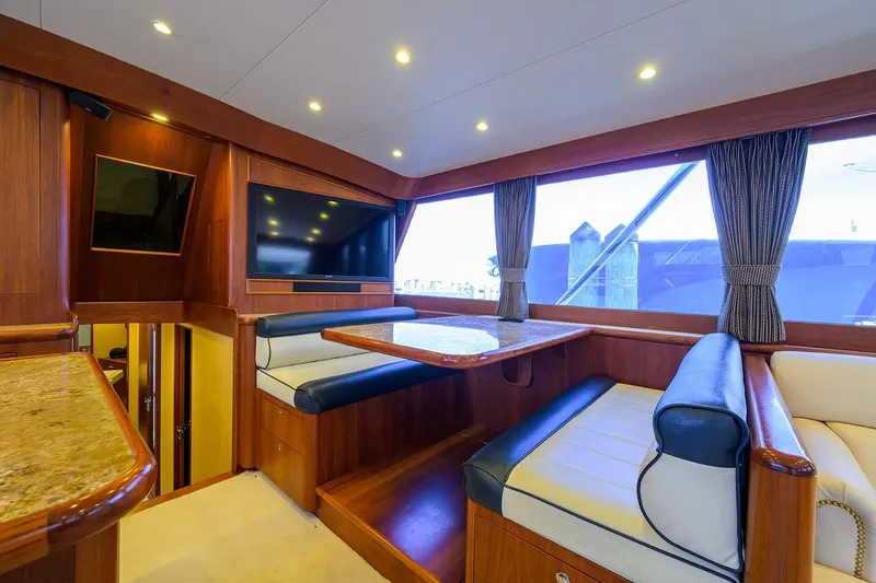 Ship's Cafe Yacht Photos Pics Luxurious interior of 1987 Merritt Sport Fisherman yacht with elegant seating and large windows.