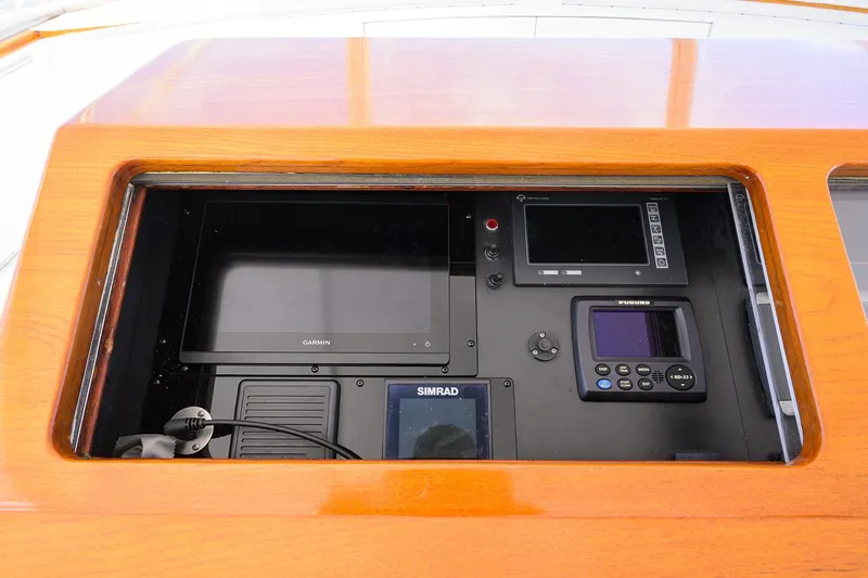 Ship's Cafe Yacht Photos Pics Control panel of a 1987 Merritt Boat Works Sport Fisherman with navigation equipment.
