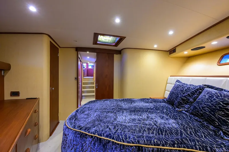 Ship's Cafe Yacht Photos Pics Luxurious bedroom interior of 1987 Merritt Sport Fisherman boat with plush bedding.