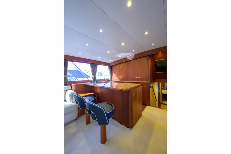 Ship's Cafe Yacht Photos Pics Luxurious interior of 1987 Merritt Sport Fisherman yacht with elegant wood finishes and seating.