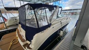 2005 Rinker Fiesta Vee 342 boat docked under a covered marina.