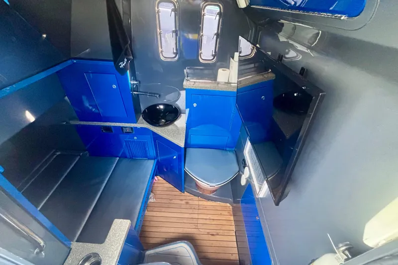  Yacht Photos Pics 2016 Hydra-Sports 4200 Siesta interior with blue cabinetry and wooden flooring.