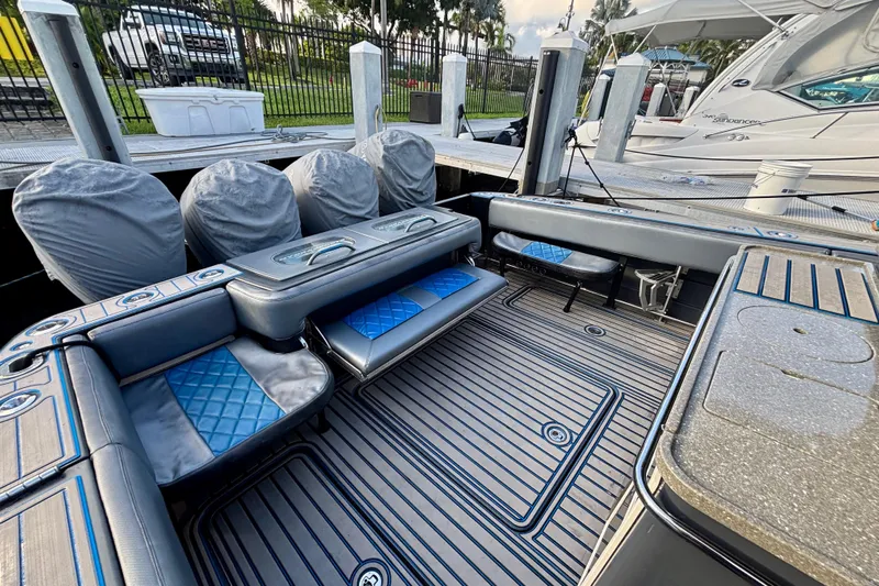  Yacht Photos Pics 2016 Hydra-Sports 4200 Siesta boat interior with cushioned seating and covered engines.