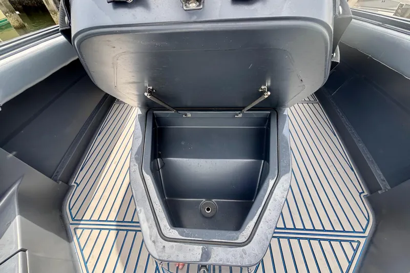  Yacht Photos Pics 2016 Hydra-Sports 4200 Siesta boat storage compartment with open lid and striped flooring.