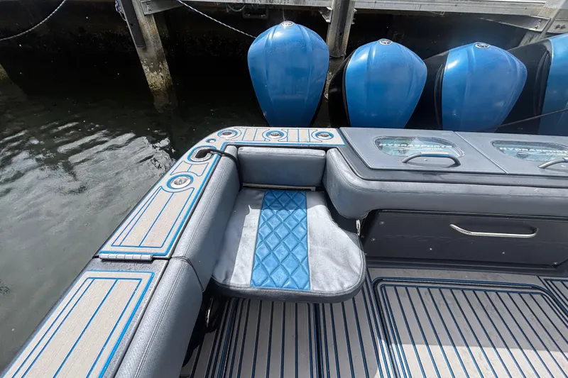  Yacht Photos Pics 2016 Hydra-Sports 4200 Siesta boat interior with blue accents and seating near water.
