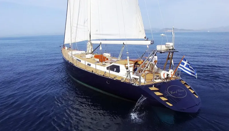 Wind Of Change Yacht Photos Pics 1988 Motorsailer Brooke Marine yacht sailing with Greek flag on open sea.