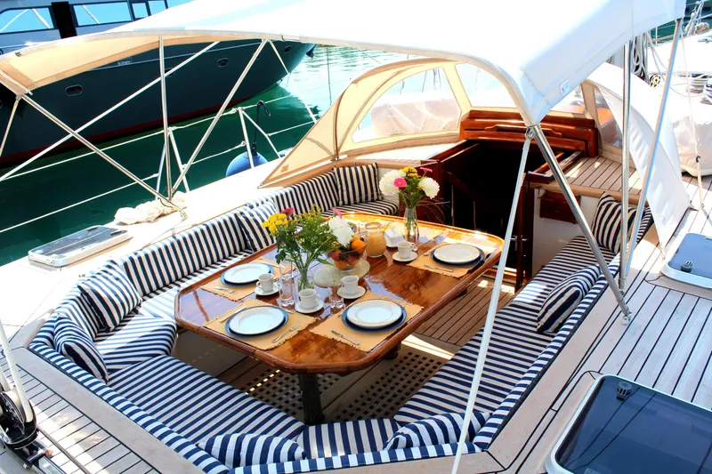 Wind Of Change Yacht Photos Pics Luxurious 1988 Motorsailer Brooke Marine with elegant outdoor dining setup.