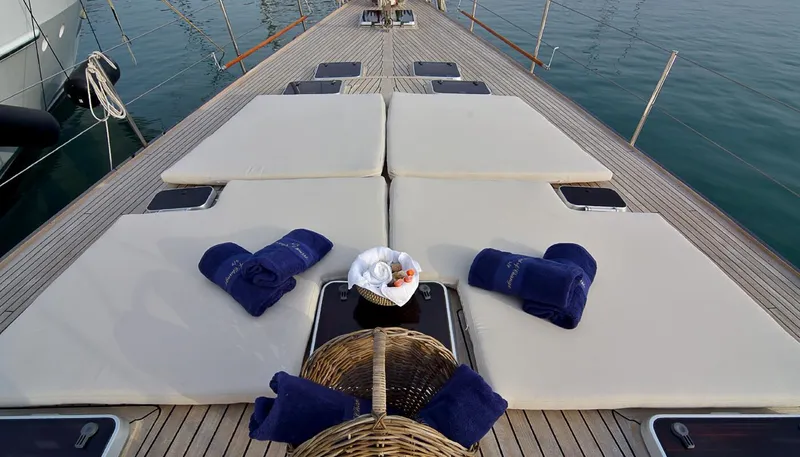 Wind Of Change Yacht Photos Pics Luxury sunbathing deck on 1988 Motorsailer Brooke Marine yacht with cushions and towels.