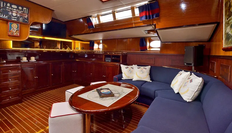 Wind Of Change Yacht Photos Pics Luxurious 1988 Brooke Marine Motorsailer interior with wooden cabinetry and cozy seating area.