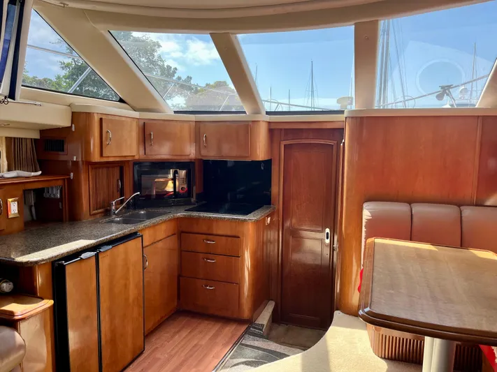 One In A Million Yacht Photos Pics Interior of 2005 Carver 444 yacht with wood cabinetry and modern amenities.