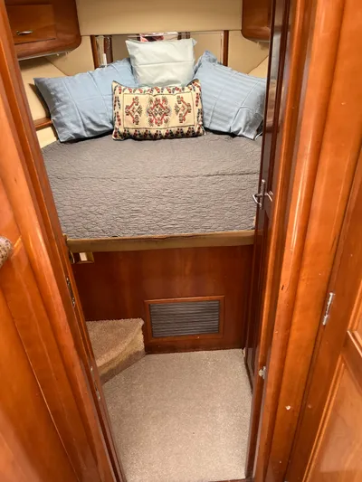 One In A Million Yacht Photos Pics Cozy cabin interior of 2005 Carver 444 with bed and decorative pillows.