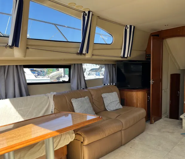 One In A Million Yacht Photos Pics Interior of 2005 Carver 444 yacht with leather sofa and modern decor.