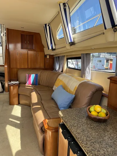 One In A Million Yacht Photos Pics Luxurious interior of 2005 Carver 444 yacht with leather seating and fruit bowl.