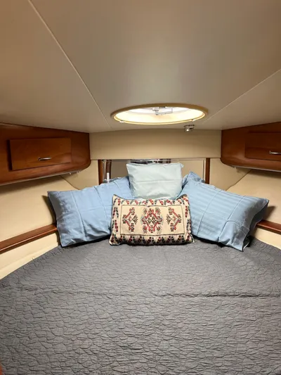 One In A Million Yacht Photos Pics Cozy cabin interior of 2005 Carver 444 with decorative pillows and wooden storage.