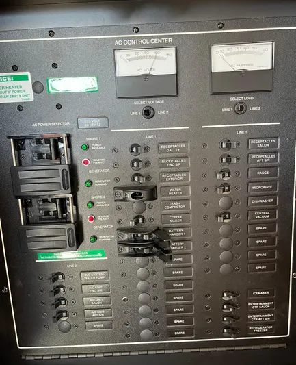 One In A Million Yacht Photos Pics AC control panel of a 2005 Carver 444 boat with switches and indicators.