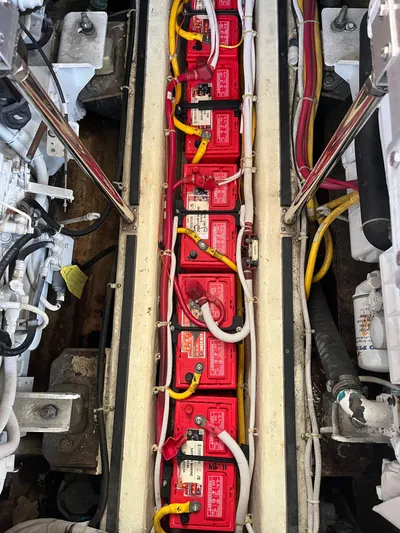 One In A Million Yacht Photos Pics Engine compartment of a 2005 Carver 444 with multiple red batteries and wiring.