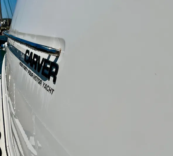One In A Million Yacht Photos Pics Side view of a 2005 Carver 444 motor yacht with logo detail.