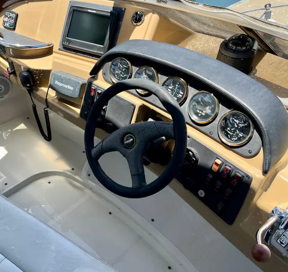 One In A Million Yacht Photos Pics 2005 Carver 444 boat dashboard with steering wheel and navigation instruments.