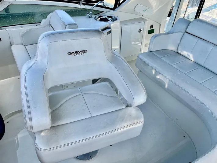 One In A Million Yacht Photos Pics 2005 Carver 444 yacht interior with white seating and helm station.